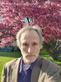 Self portrait (6 June 2022) @ 6:27 p.m. with flowering apple tree.